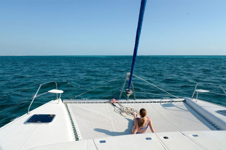 Gilr sunbathing catamaran